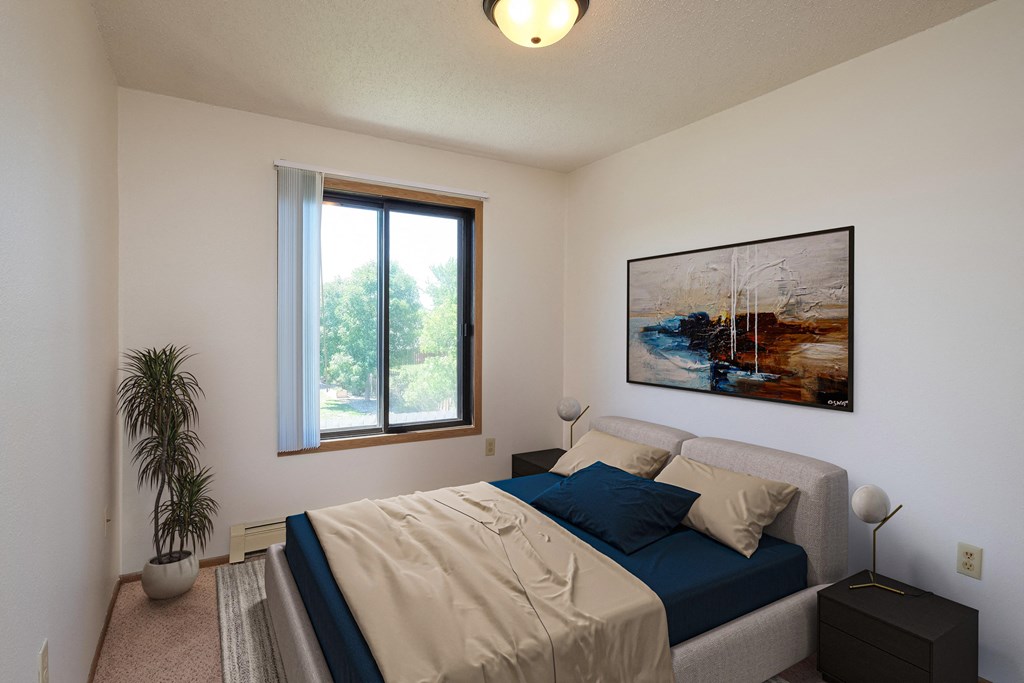 a bedroom with a bed and a painting on the wall. Fargo, ND Hazelwood Townhomes