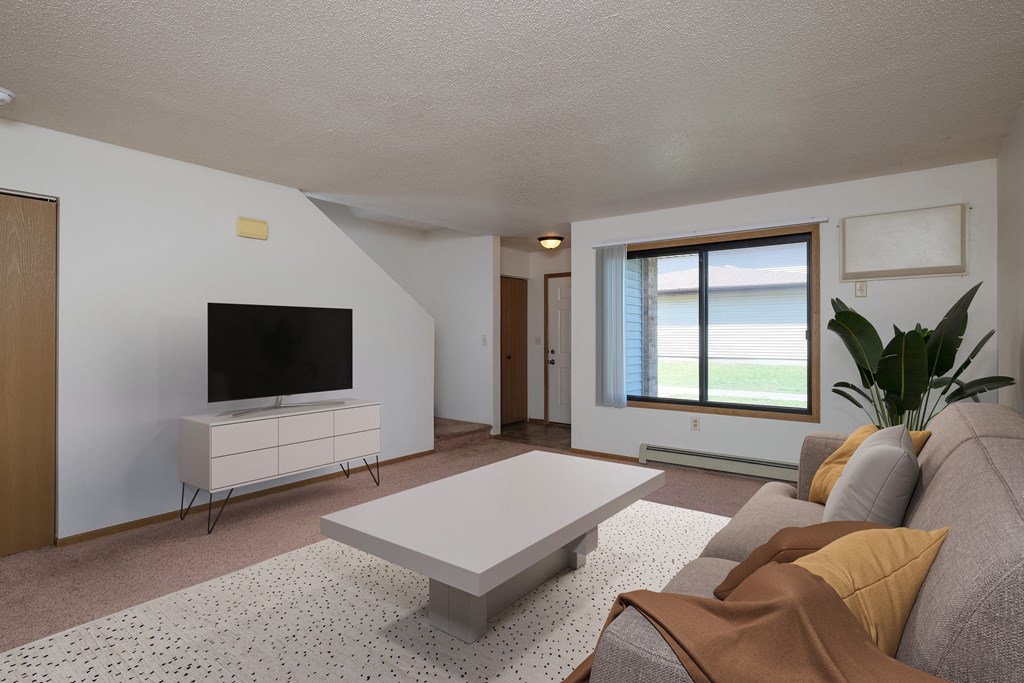 a living room with a couch and a coffee table. Fargo, ND Hazelwood Townhomes