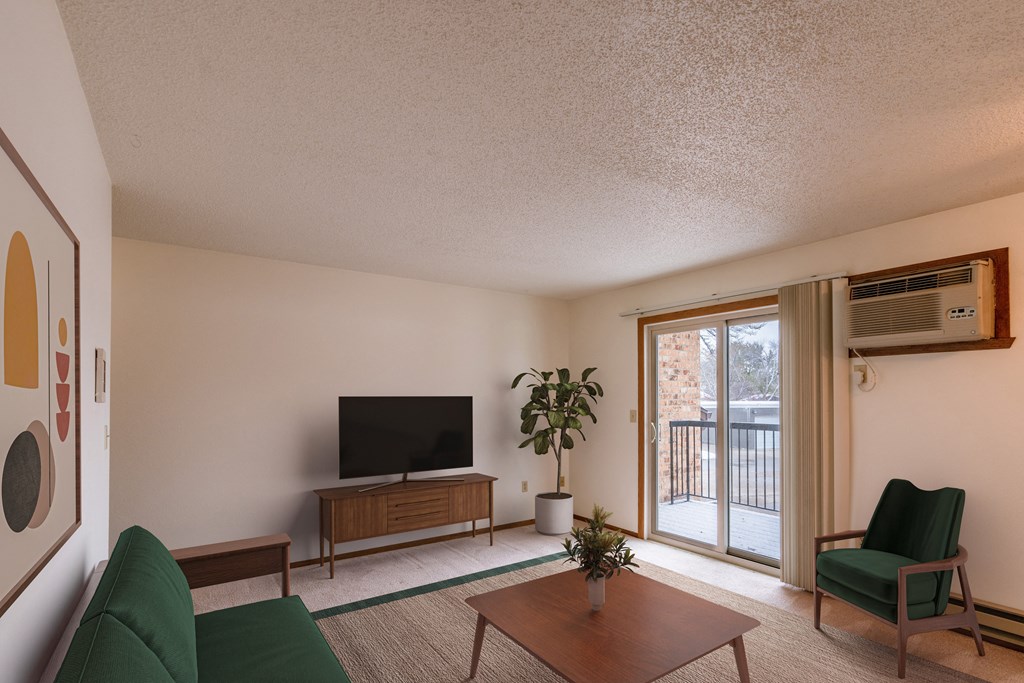 a living room with a couch and a table and a tv. Fargo, ND Huntington Apartments