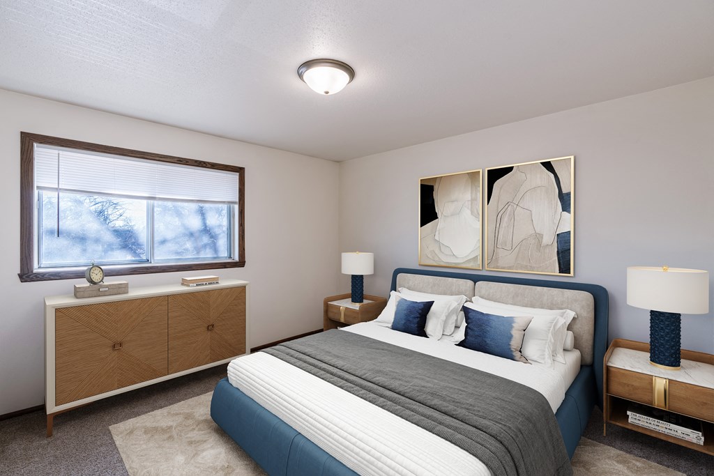 a bedroom with a bed and a window. Fargo, ND Jadestone Apartments