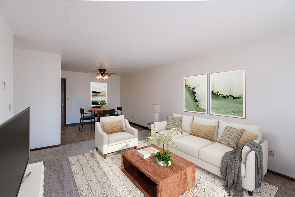 a living room with a white couch and a coffee table. Fargo, ND Jadestone Apartments
