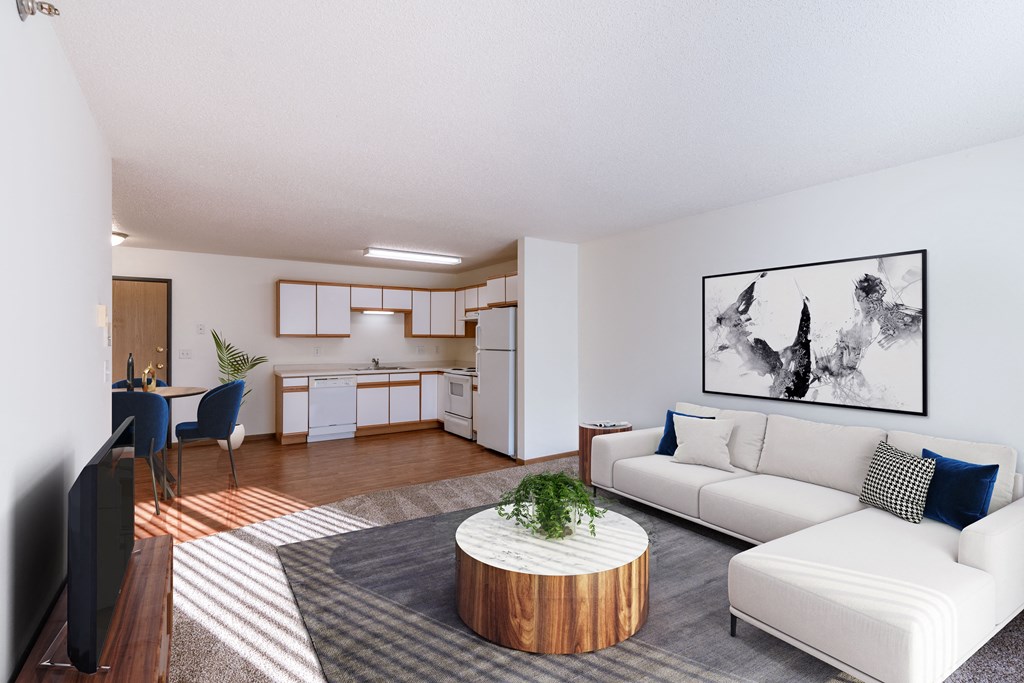 a living room with a white couch and a table. Fargo, ND Lake Crest Apartments