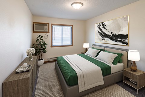 Fargo, ND Lake Crest Apartments. A bedroom with a large painting on the wall and a bed with a green blanket