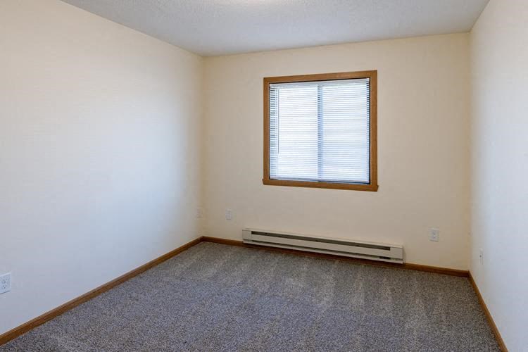 Fargo, ND Lake Crest Apartments. A room with a window and carpet
