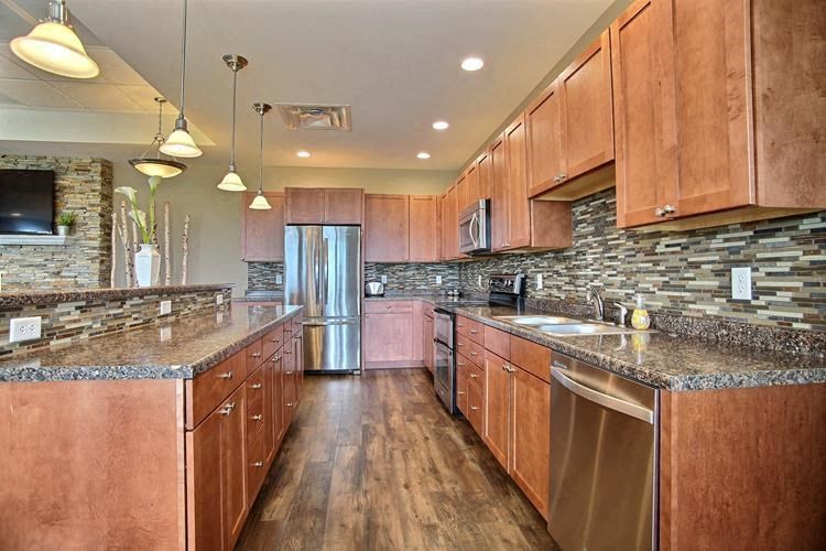 Fargo, ND Lake Crest Apartments. A large kitchen with wooden cabinets and stainless steel appliances
