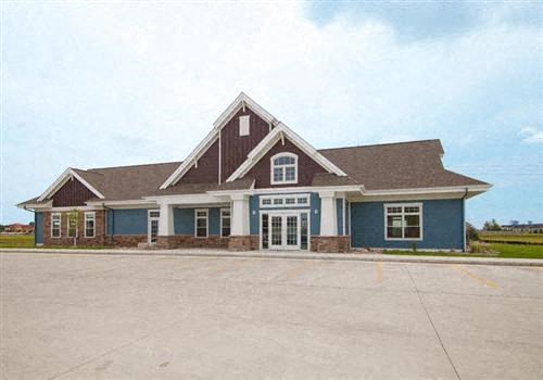 Fargo, ND Lake Crest Apartments. A large house with a parking lot in front of it