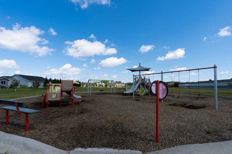 Fargo, ND Lake Crest Apartments. a playground on a sunny day