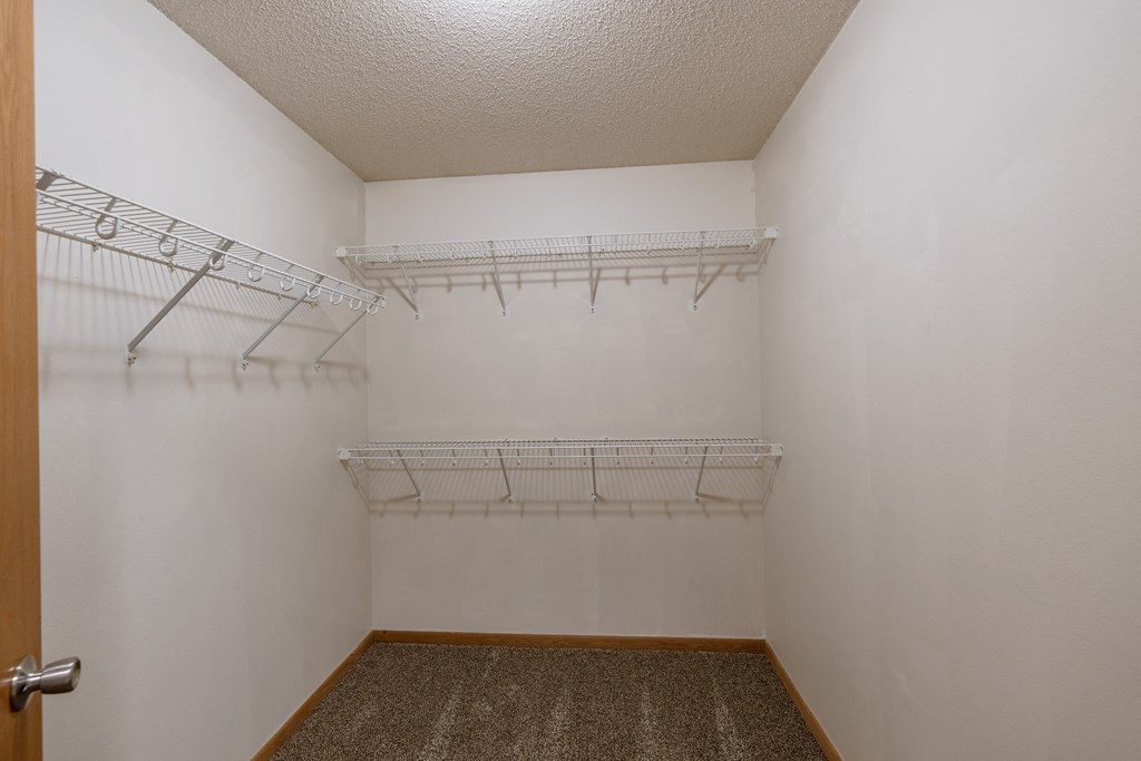 a closet with three shelves. Moorhead, MN Mallard Creek Apartments