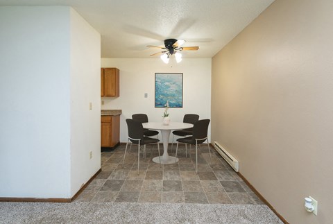 a dining area with a table and chairs. Fargo, ND Maplewood Bend Apartments