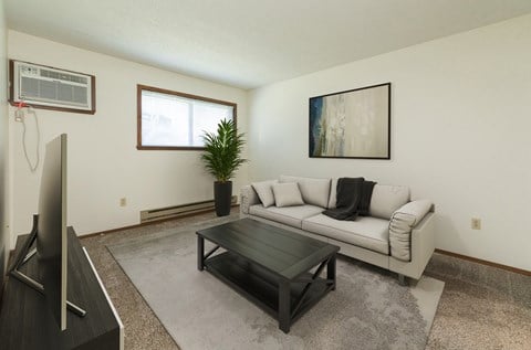 a living room with a couch and a coffee tableFargo, ND Maplewood Bend Apartments