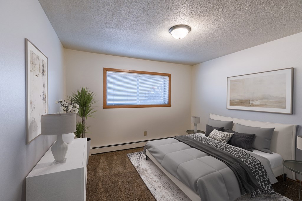a bedroom with a bed and a large window. Fargo, ND Martha Alice Apartments