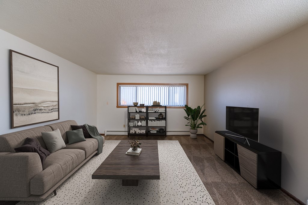 a living room with a couch and a coffee table. Fargo, ND Martha Alice Apartments