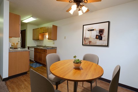a dining room with a table and chairs and a kitchen