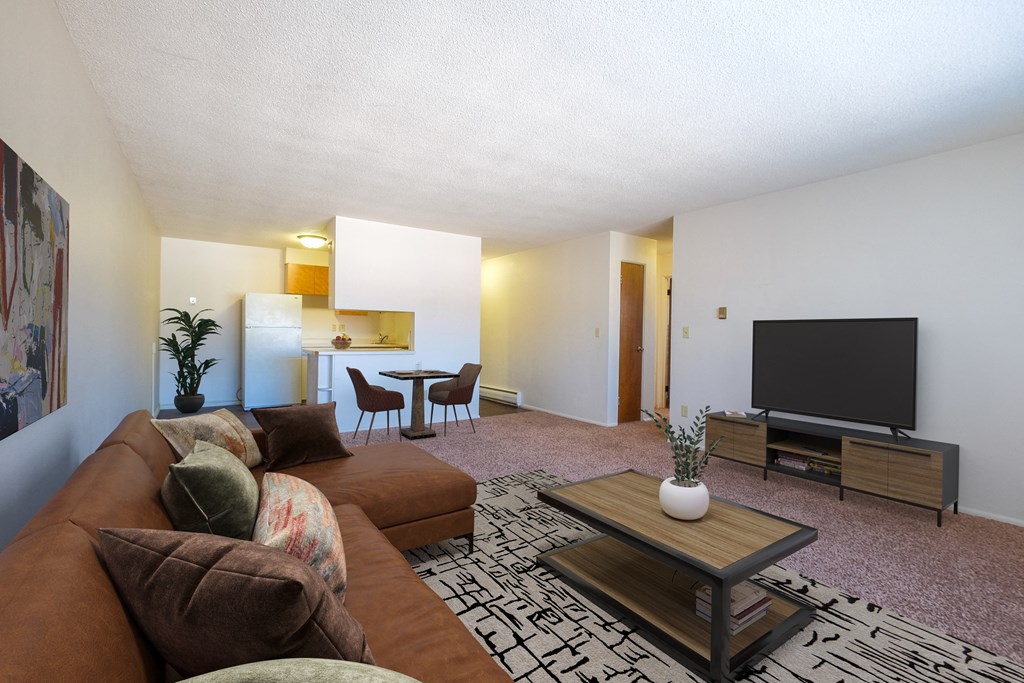 a living room with a couch and a television. Fargo, ND North Manor Apartments