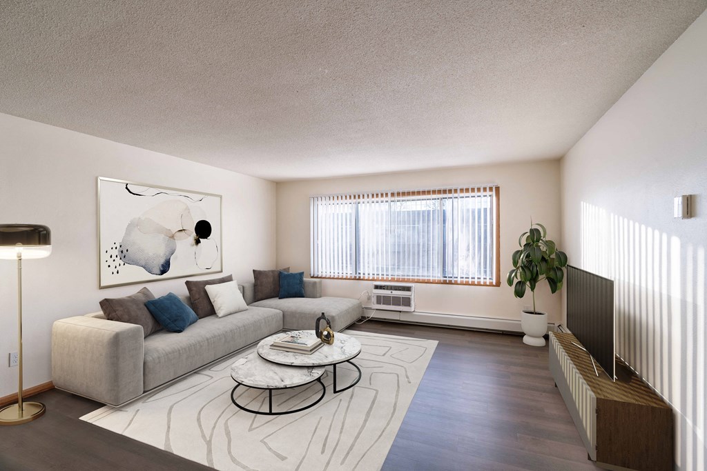 a living room with a couch and a coffee table. Fargo, ND North Manor Apartments