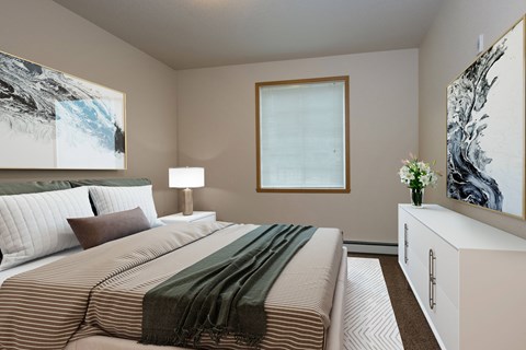 a bedroom with a large bed and a window. Fargo, ND North Sky Apartments