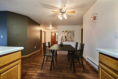 Fargo, ND Oxford Apartments. a dining room with a table and chairs