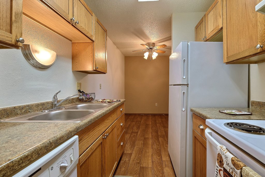 a kitchen with a sink and a refrigerator. Fargo, Pacific Park II Apartments