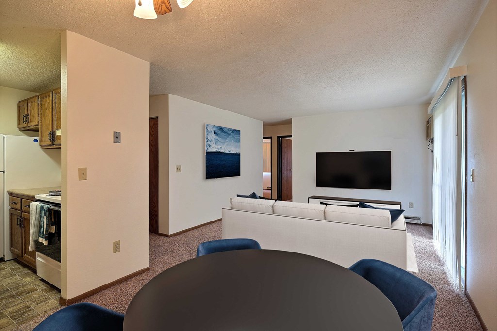 a living room with a couch and a table. Fargo, ND Pacific South Apartments