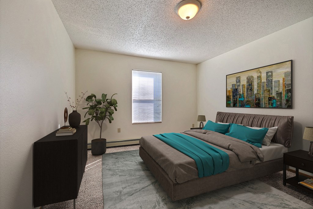 a bedroom with a bed and a dresser and a window. Fargo, ND Park Place Apartments