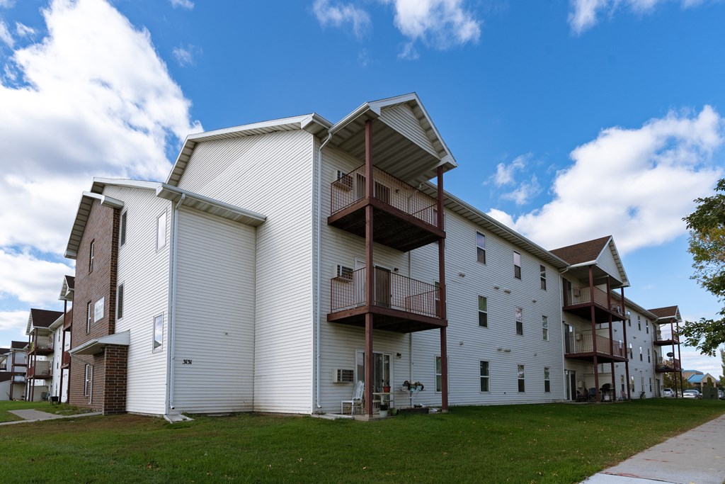 a building with a balcony on top of it. Fargo, ND Park Place Apartments