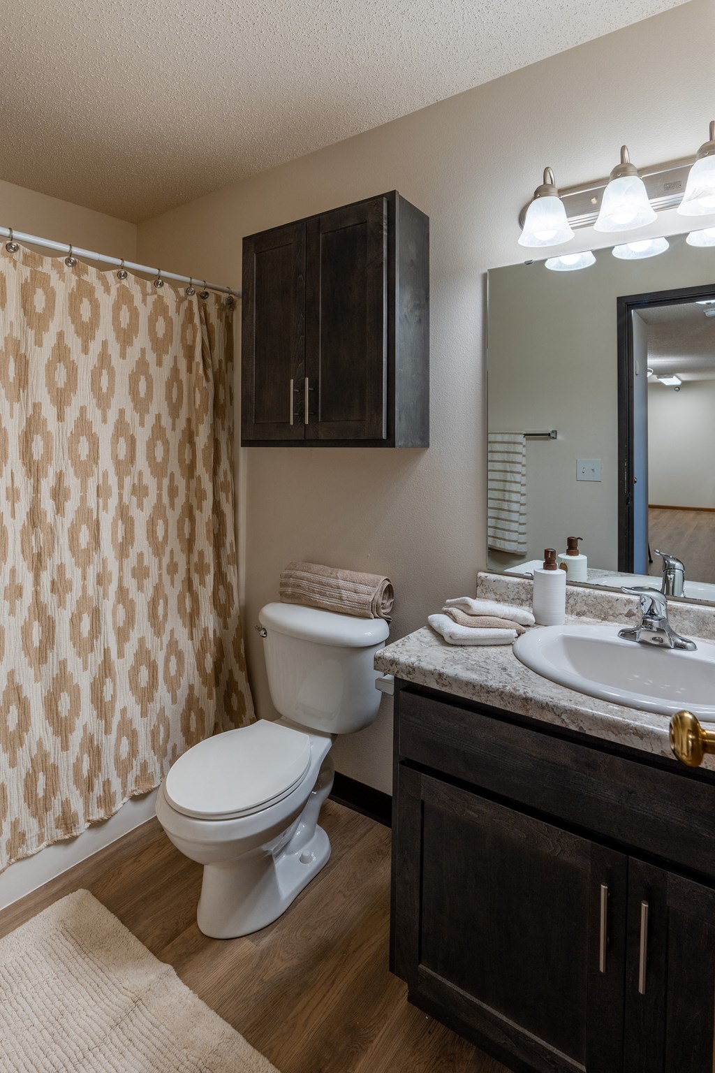 Fargo, ND Parkside Apartments. A bathroom with a toilet, sink, and bathtub