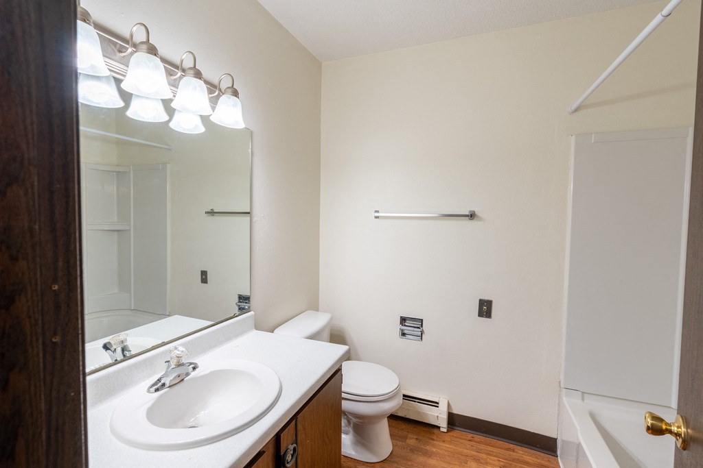 Bathroom with a white sink and toilet next to a white bathtub at Parkwest Gardens 58078