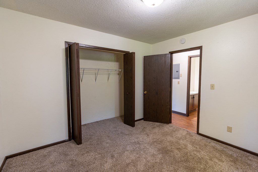 Bedroom with two closets and a carpeted floor at Parkwest Gardens West Fargo