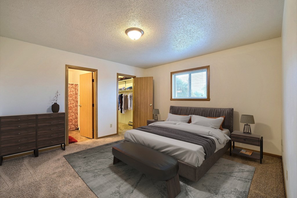 Fargo, ND Parkwest Gardens Apartments. a bedroom with a bed and a dresser