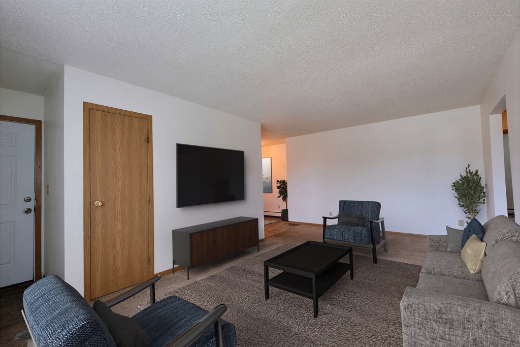 Living room filled with furniture and a flat screen tv at Parkwest Gardens West ND 58078