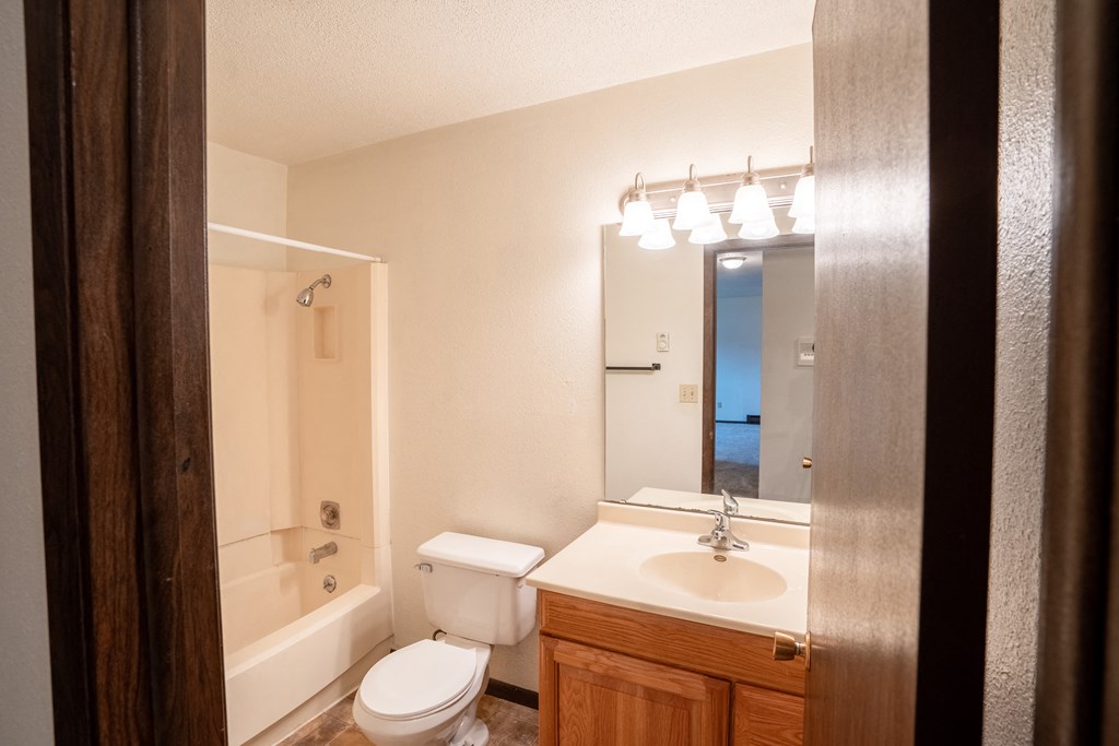 Fargo, ND Patricia Ann Apartments. A bathroom with a toilet sink and bathtub