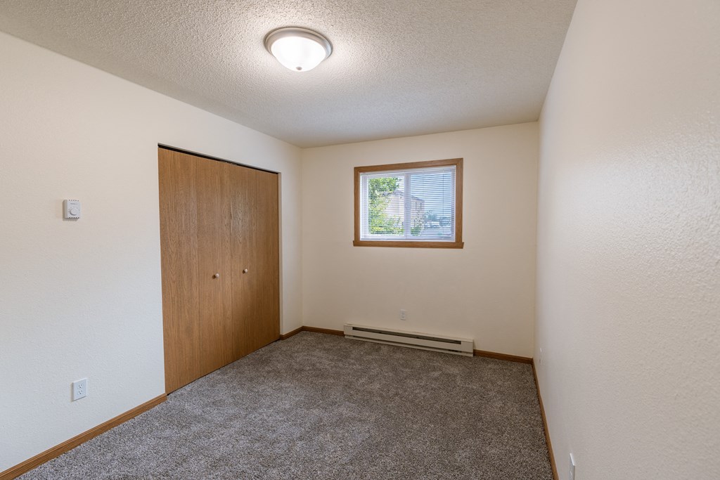 Fargo, ND Patricia Ann Apartments. A bedroom with a door and a window