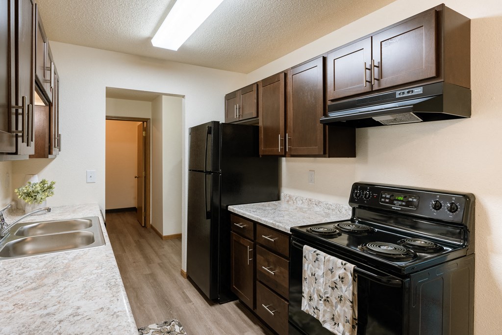 Fargo, ND Patricia Ann Apartments. A kitchen with black appliances.
