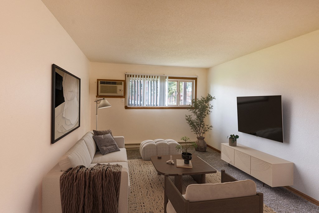 a living room with a couch and a tv. Fargo, ND Patricia Ann Apartments