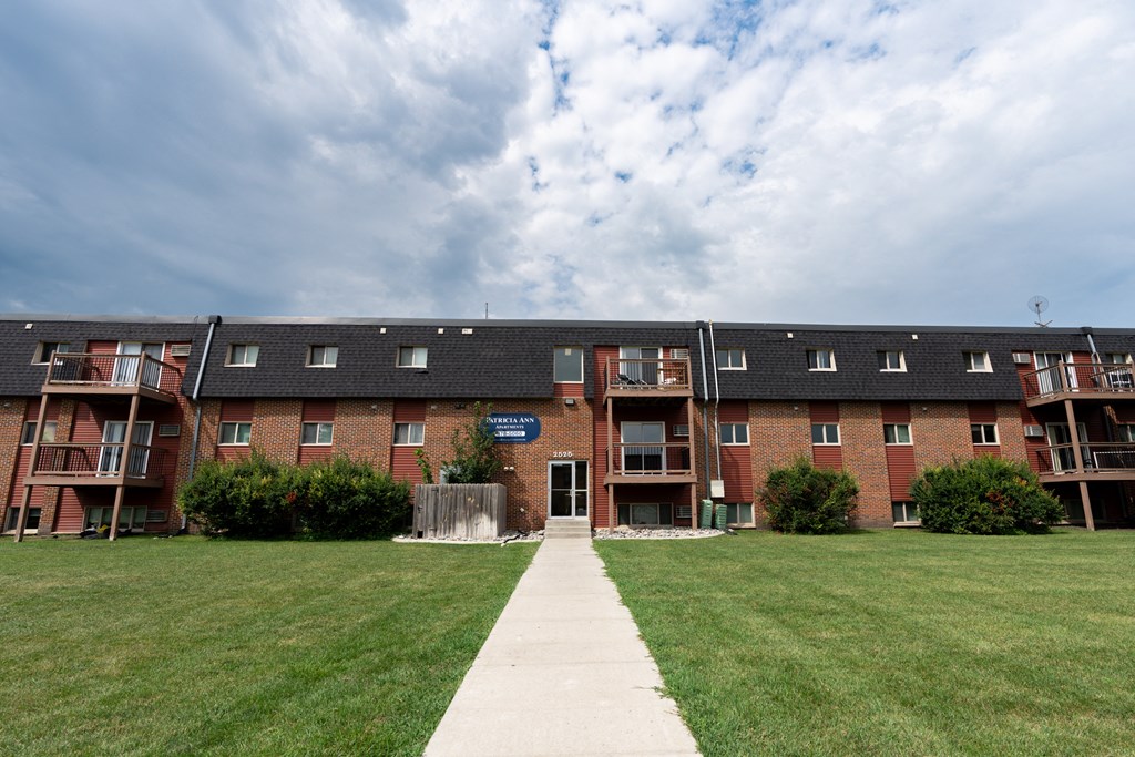 Fargo, ND Patricia Ann Apartments. A pathway leading to a brick building with balconies