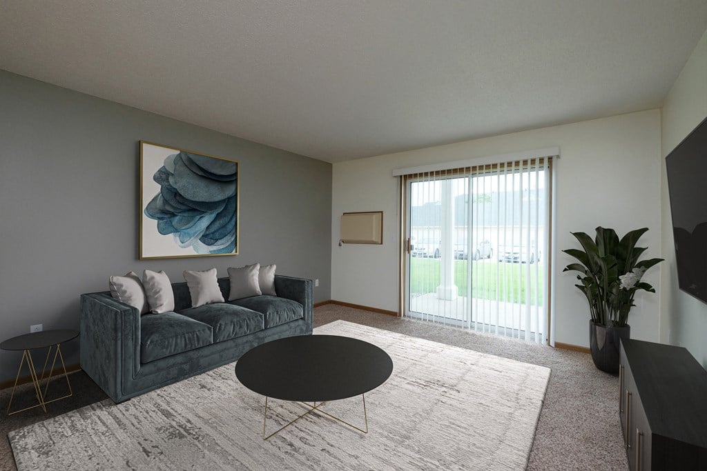 A living room with a couch and a coffee table. Fargo, ND Pinehurst Apartments.