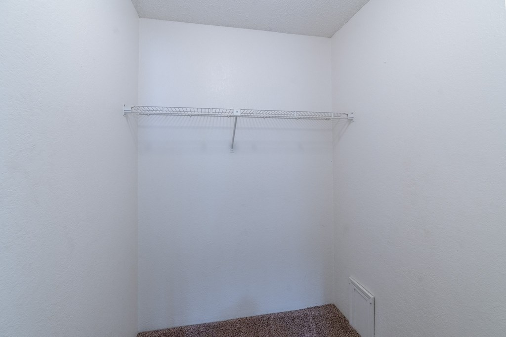 an empty room with a white wall and a white closet. Fargo, ND Place One Apartments