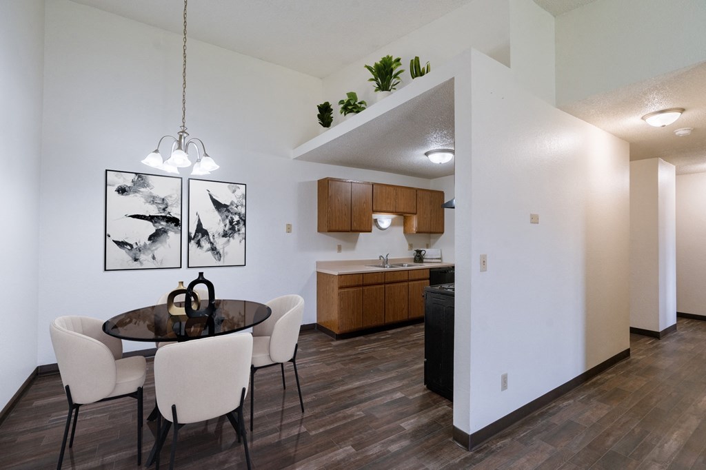an open kitchen and dining room with a table and chairs. Fargo, ND Place One Apartments