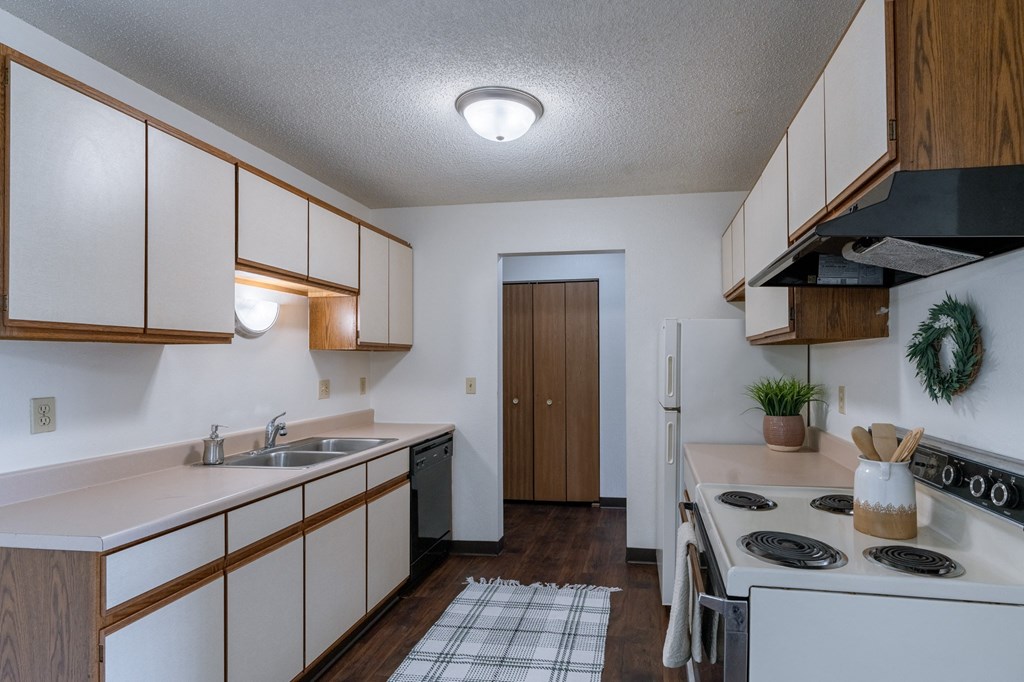 a kitchen with stove and sink. Fargo, ND Place One Apartments