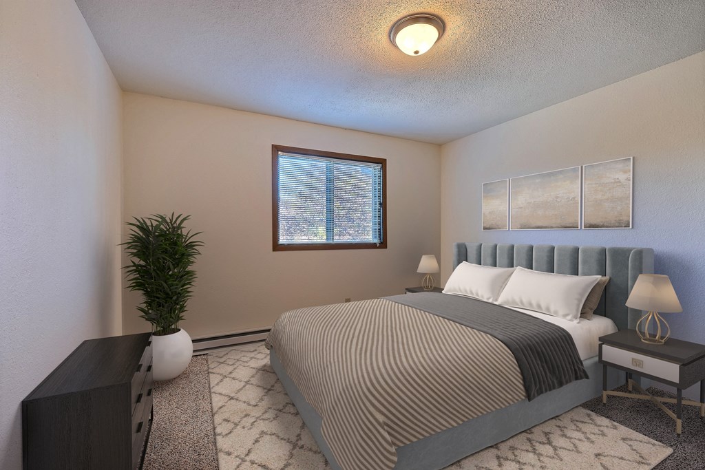 a bedroom with a bed and a plant and a window