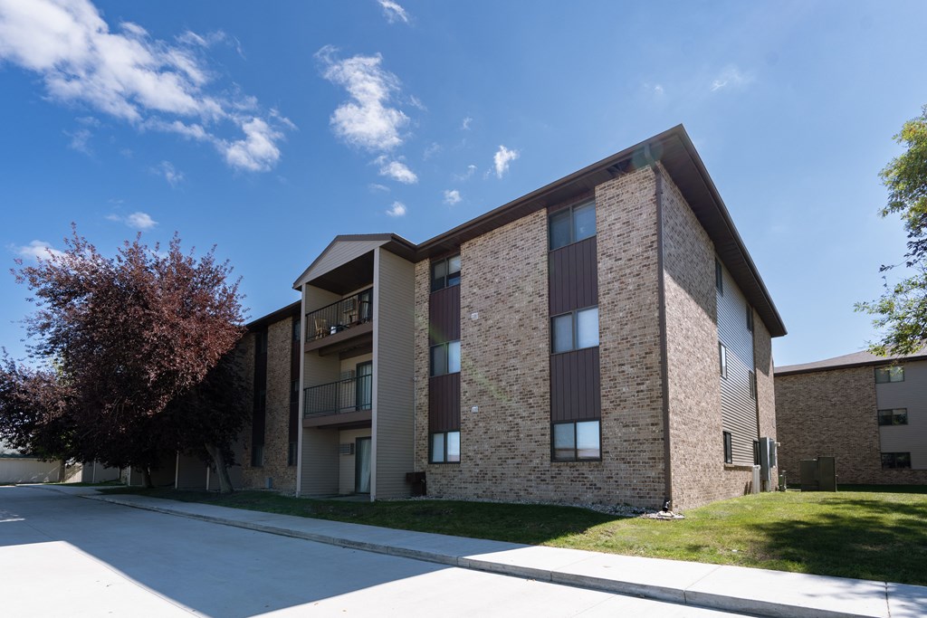 An exterior of a three level apartment. Fargo, ND Place One Apartments.