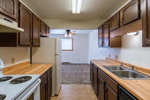 the view of a kitchen with a stove sink and refrigerator