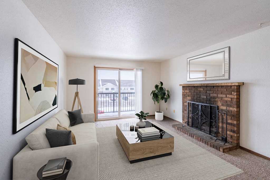 a living room with a fireplace and a couch and a table. Fargo, ND Plumtree Apartments