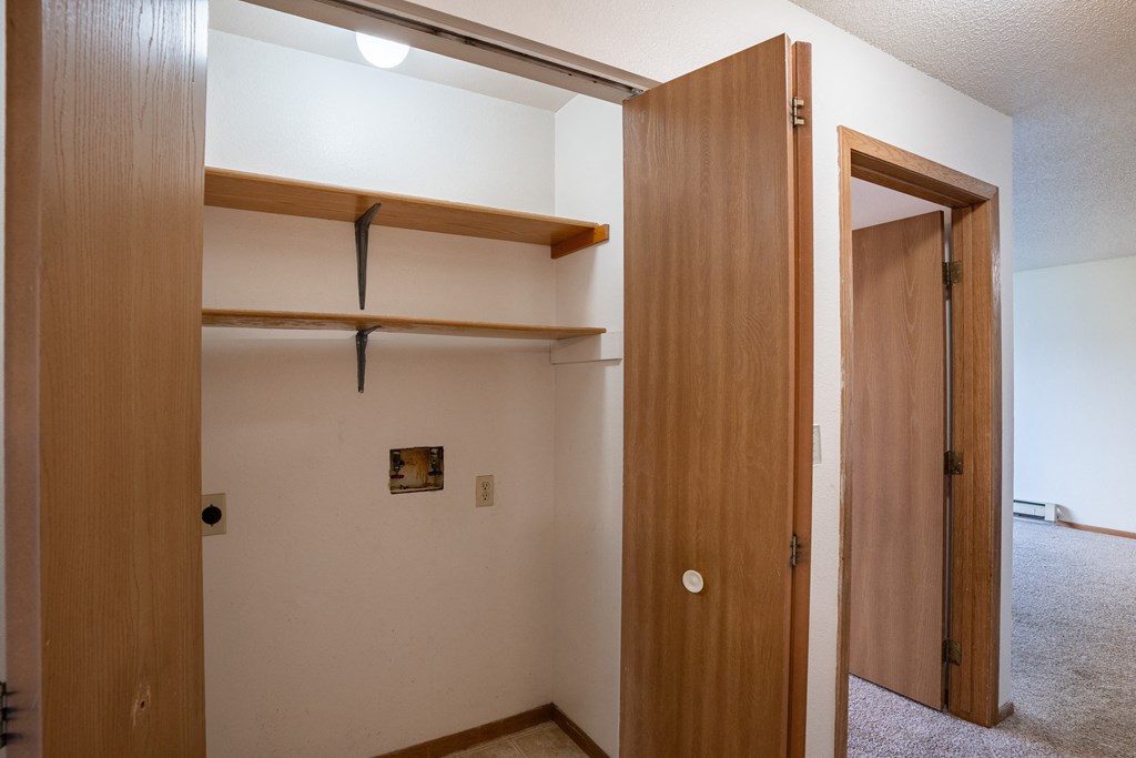 an empty room with a closet and an open door. Fargo, ND  Prairie Park Apartments