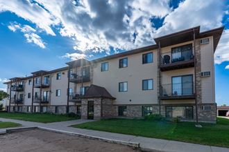 Fargo, ND Prairie Park Apartments. An apartment building with a cloudy sky in the background