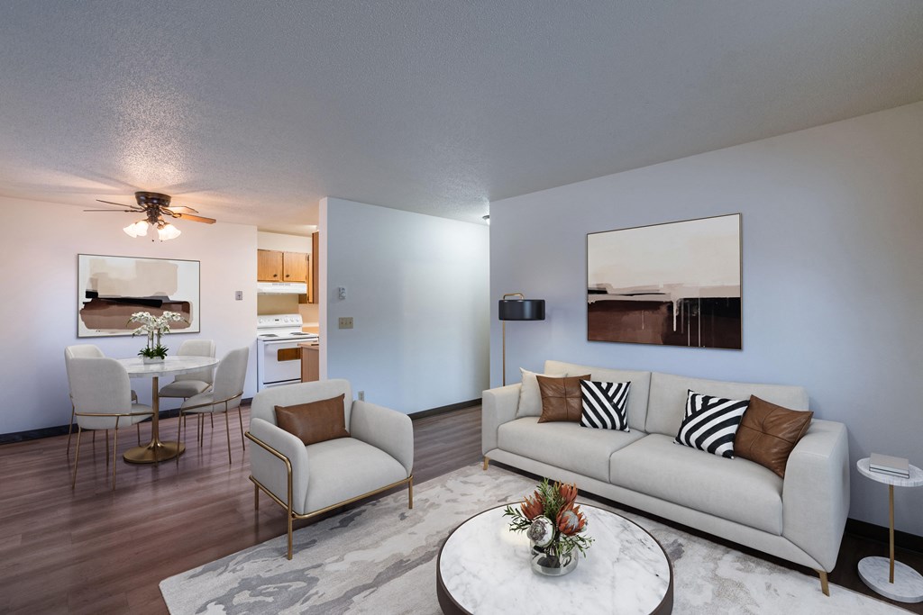 a living room with a couch and a table. Fargo, ND Prairiewood Courts Apartments