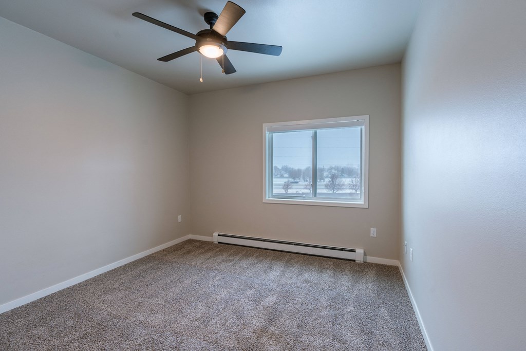 an empty room with a ceiling fan and a window. Fargo, ND Prairiewood Meadows | LivingFargo, ND Prairiewood Meadows