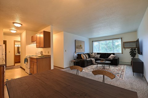 Fargo, ND Saddlebrook Apartments. a living room with a couch and a table