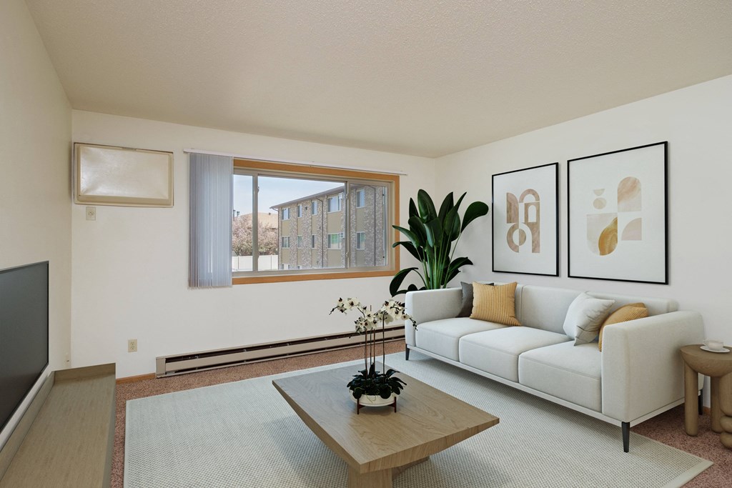 a living room with a couch and a coffee table. Fargo, ND Sargent Apartments