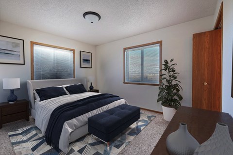 a bedroom with a bed and two windows. Fargo, ND Somerset Apartments
